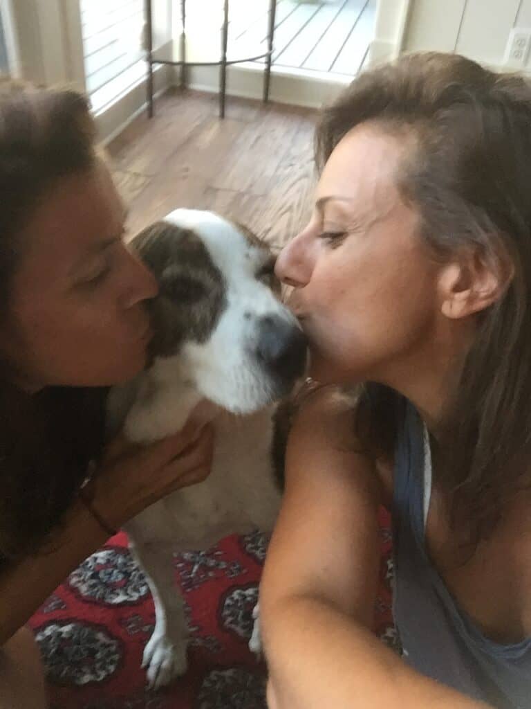 A picture of Karen and Donna giving Chuckles a kiss on the snout.