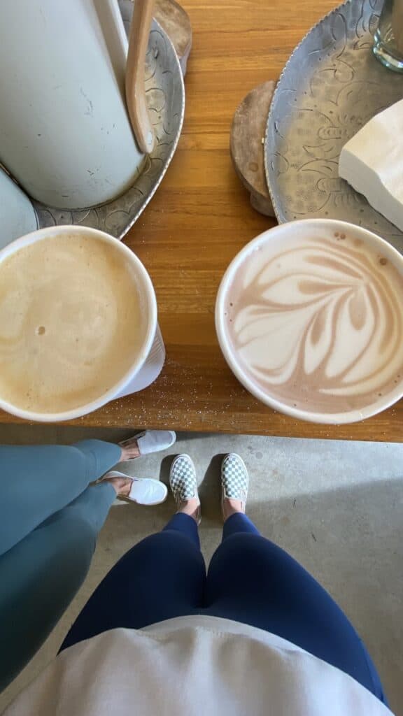 A picture of our feet and coffee cups from a local cafe while we were on a pet sit.