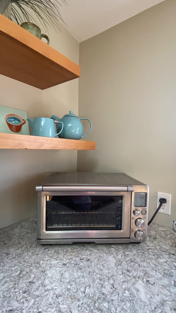 A picture of a toaster over, which is something we don't have in our campervan and is something we look forward to using during Trusted Housesitters sits.