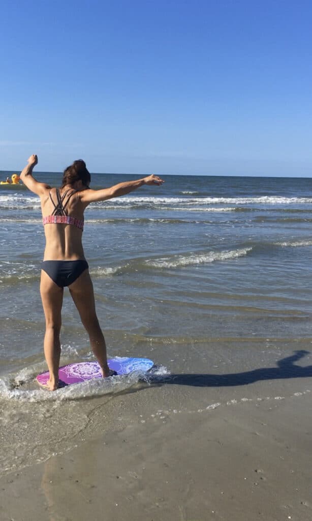 Donna skim boarding on the beach in South Carolina.