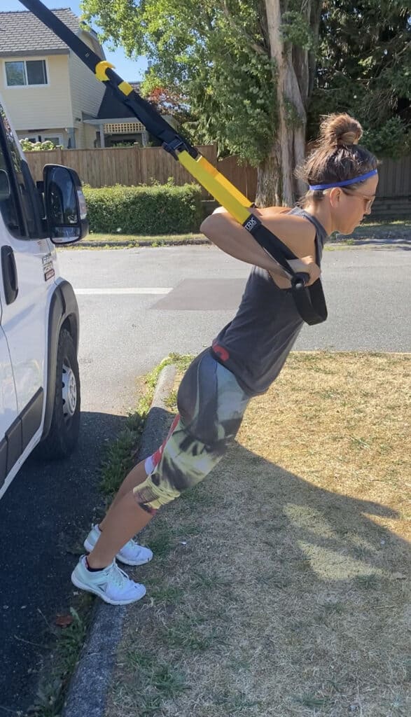 A picture of Donna exercising with our TRX equipment.